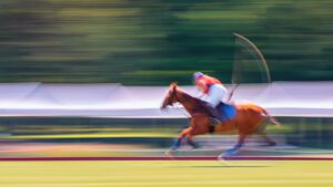 A photograph of a polo athlete about to hit the ball.