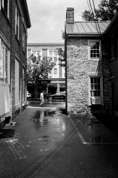 Man walking past an alley in Doylestown