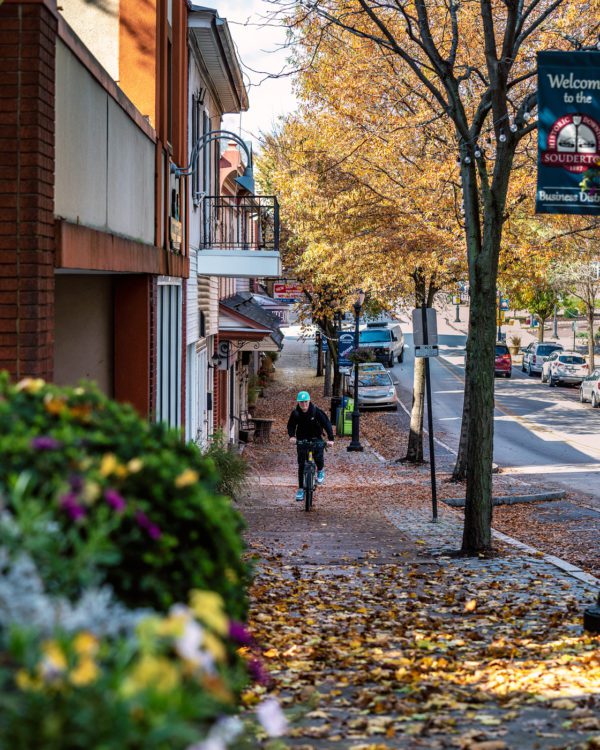 Photo of Souderton Main Street from the top of the hill with a bicyclist - Fall 2022