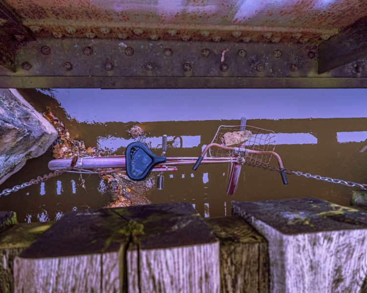 Bike hanging from graffiti bridge in Lambertville, NJ